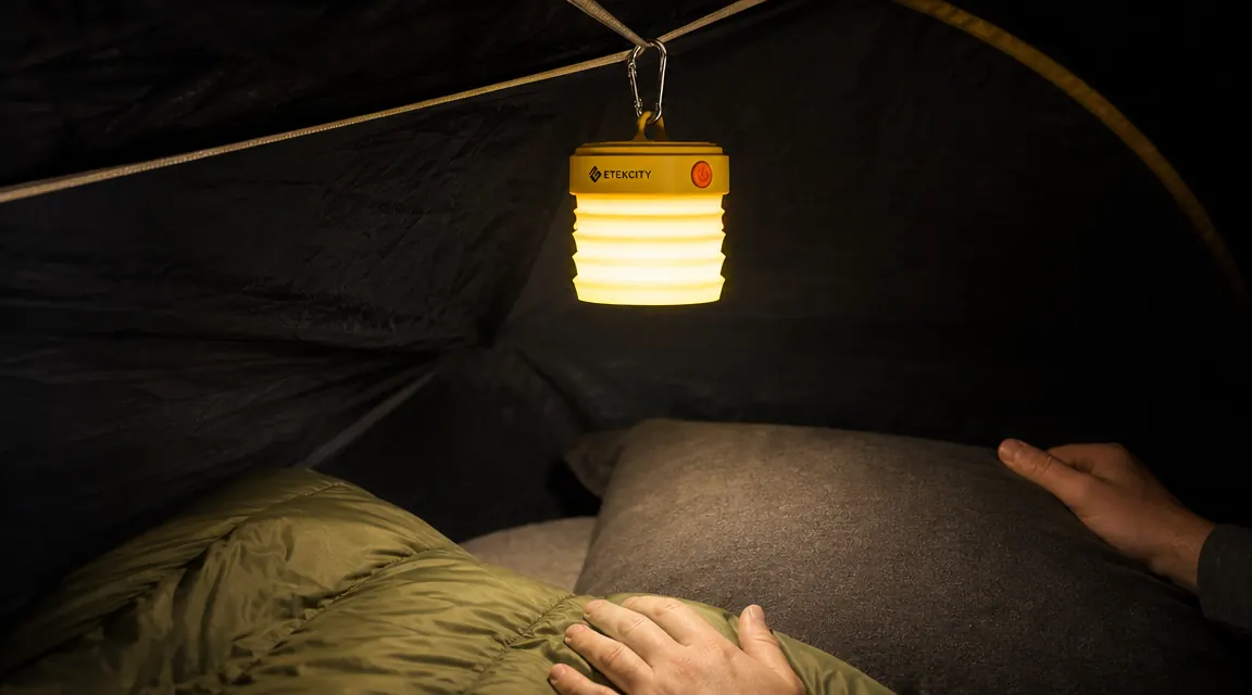 Etekcity lantern hanging from a tent ridge-line clip, illuminating tent interior at night